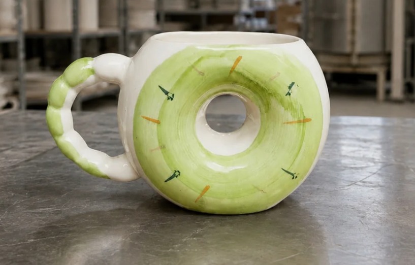 White ceramic mug with a green kiwi slice on its side